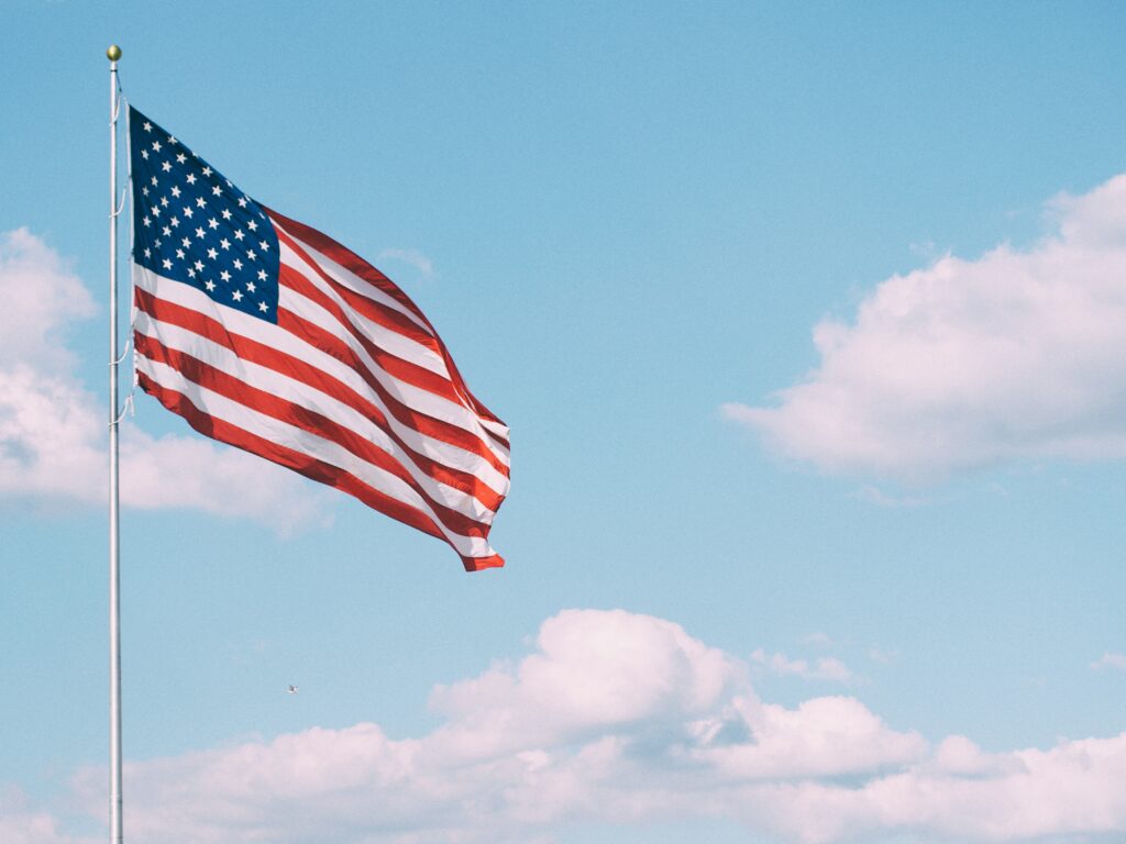 An American Flag Flies - Photo by Aaron Burden via Unsplash